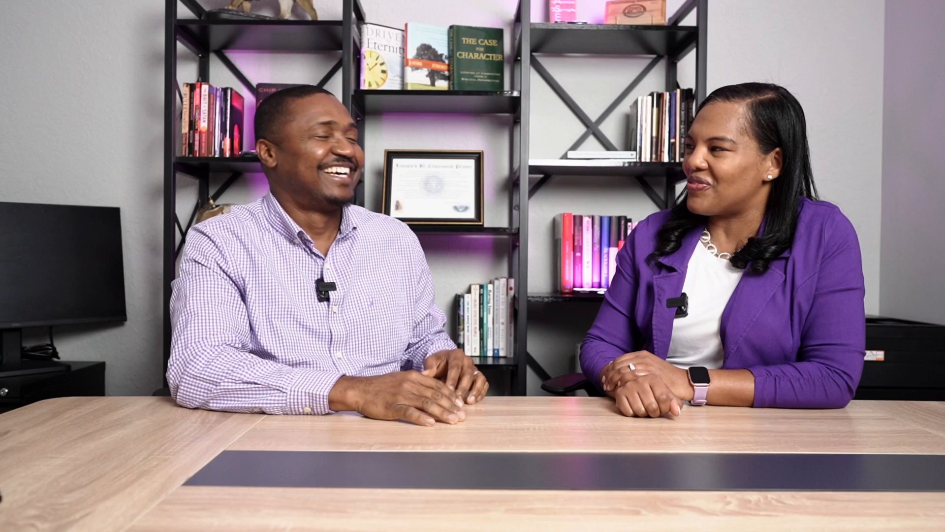 Bristan and Latondra Heaven talking together at their desk