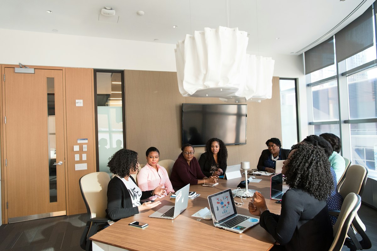 A group of professionals meeting around a boardroom table